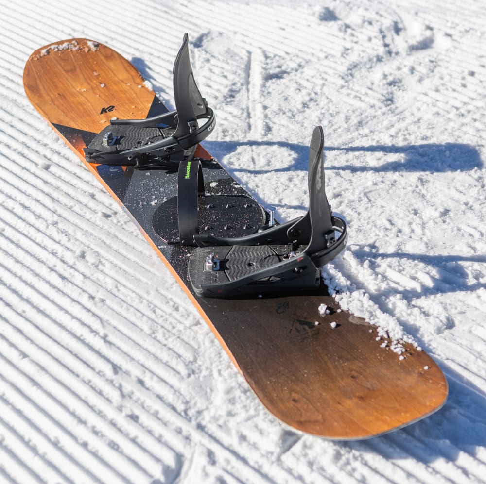 A snowboard with two different types of wooden handles.